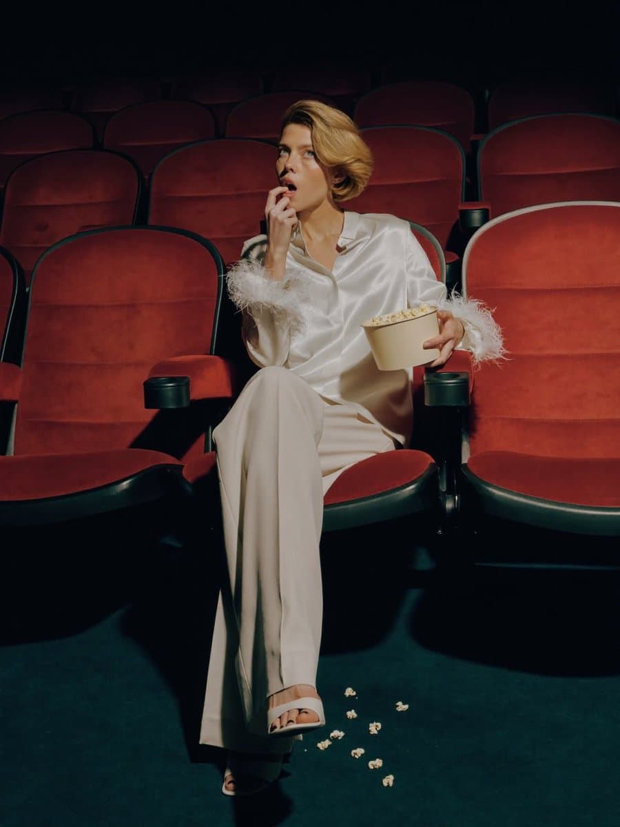 Elegant Fashion Editorial in a Dark Movie Theater — example 1